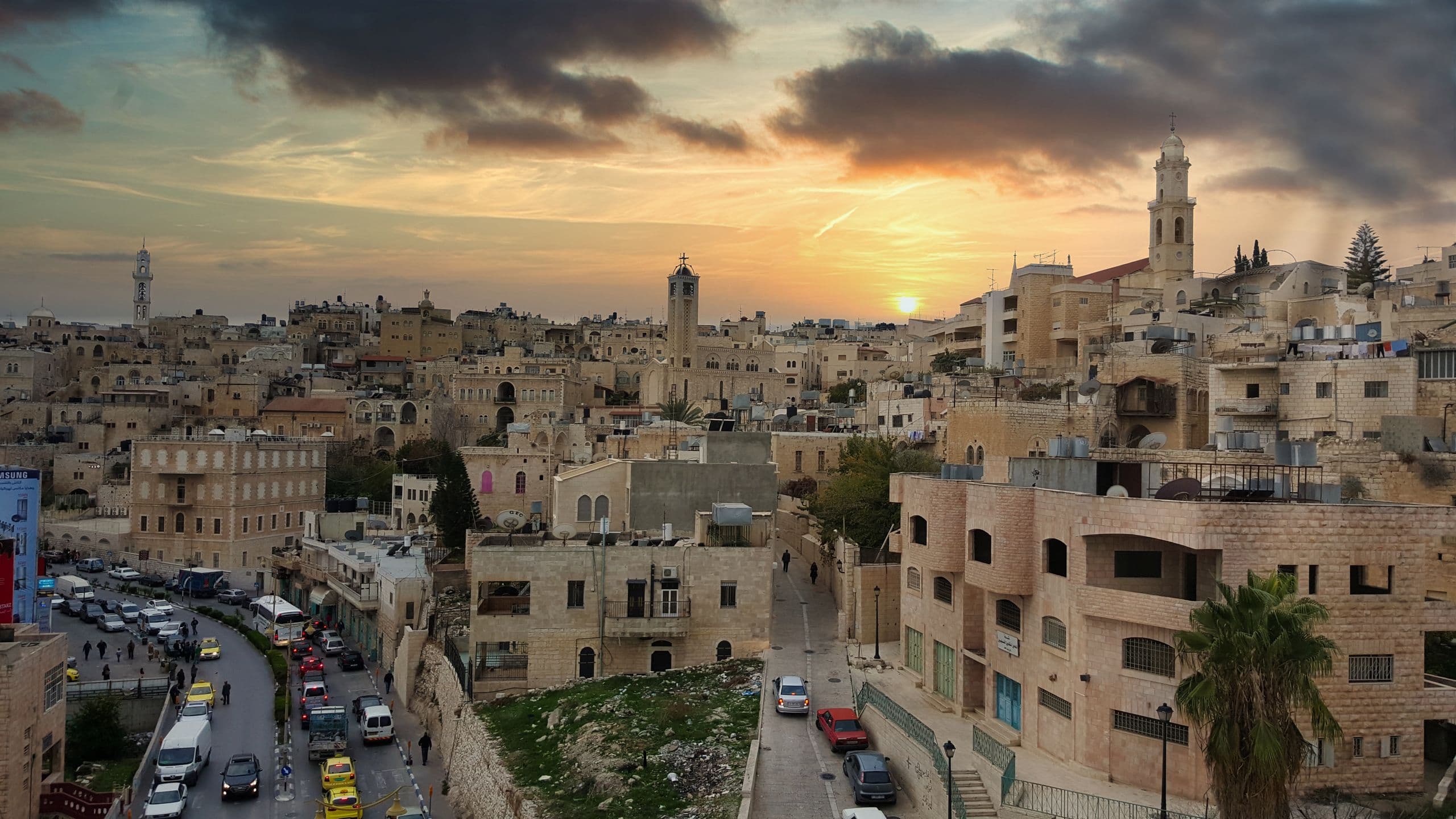 Bethlehem at sunset, church towers above the stone houses